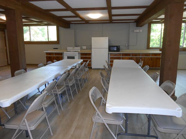 tables and chairs set up inside recreational building